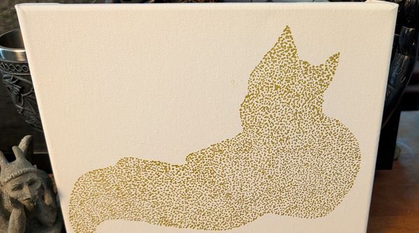 A reclining cat rendered entirely in gold stippled dots on white