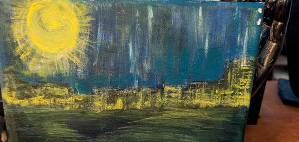 Yellow moon over a blue and green aurora above a dark treeline