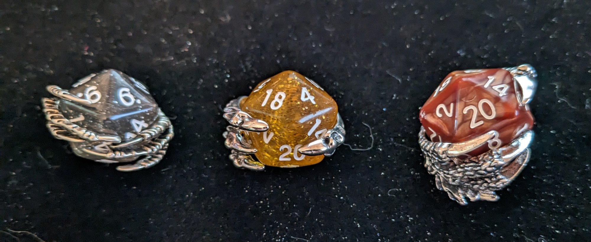 Dragon claw pendants holding d20 dice