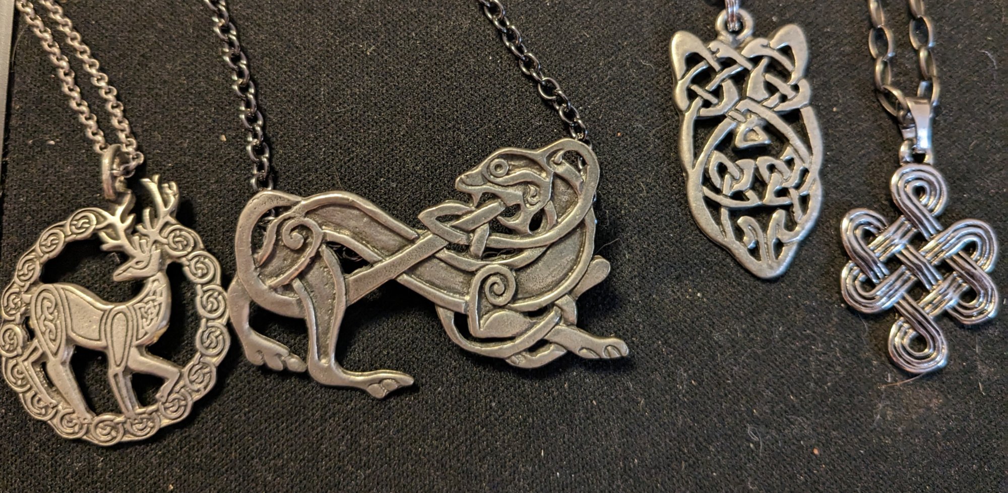 Celtic knotwork pendants — stag, hound, and dragon