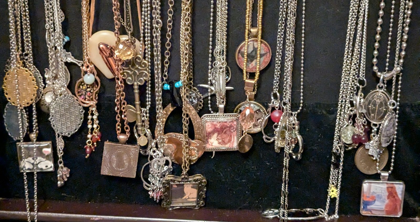 A mixed display of pendants, rings, and curiosities