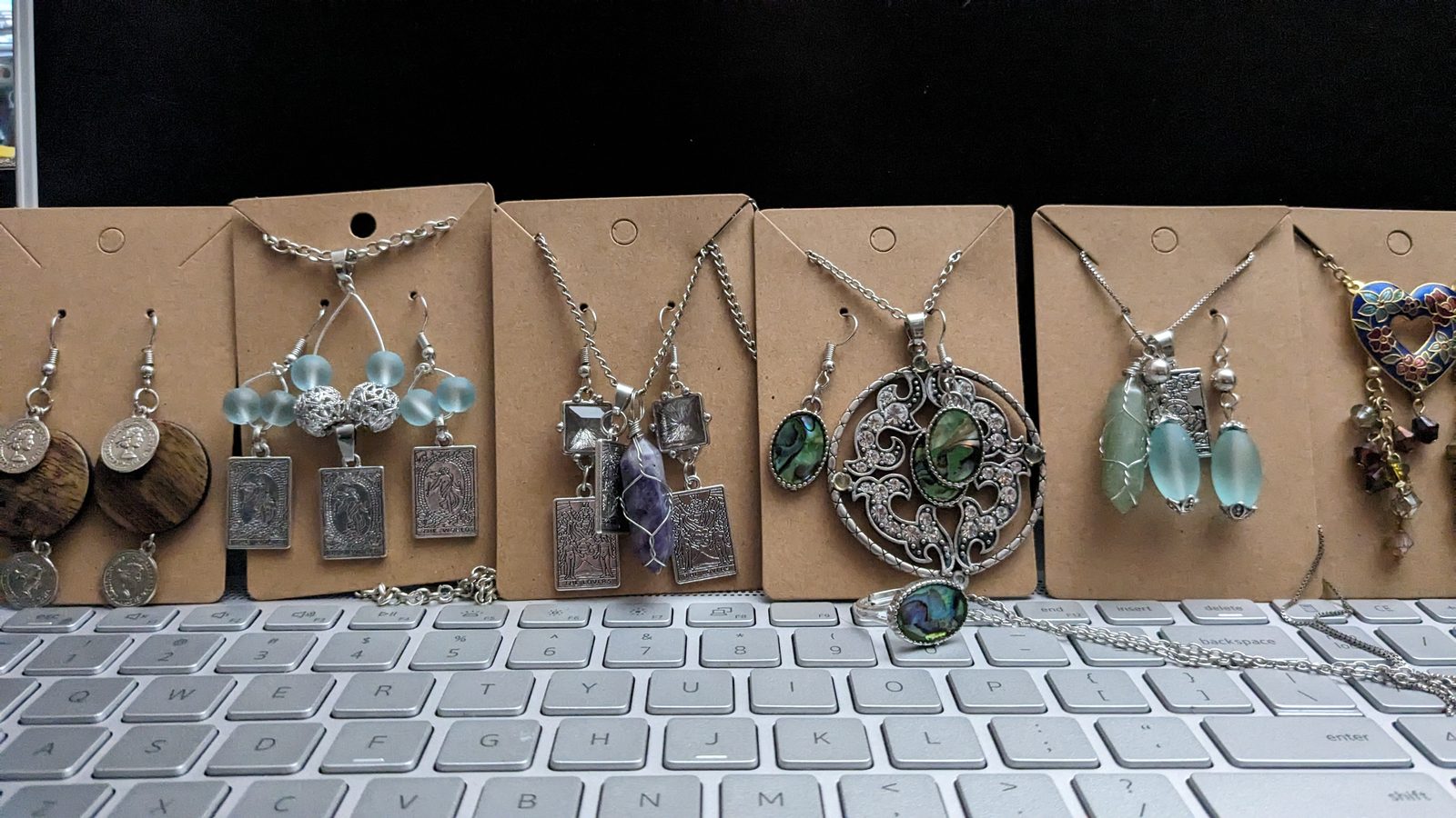 A mixed display of pendants, rings, and curiosities